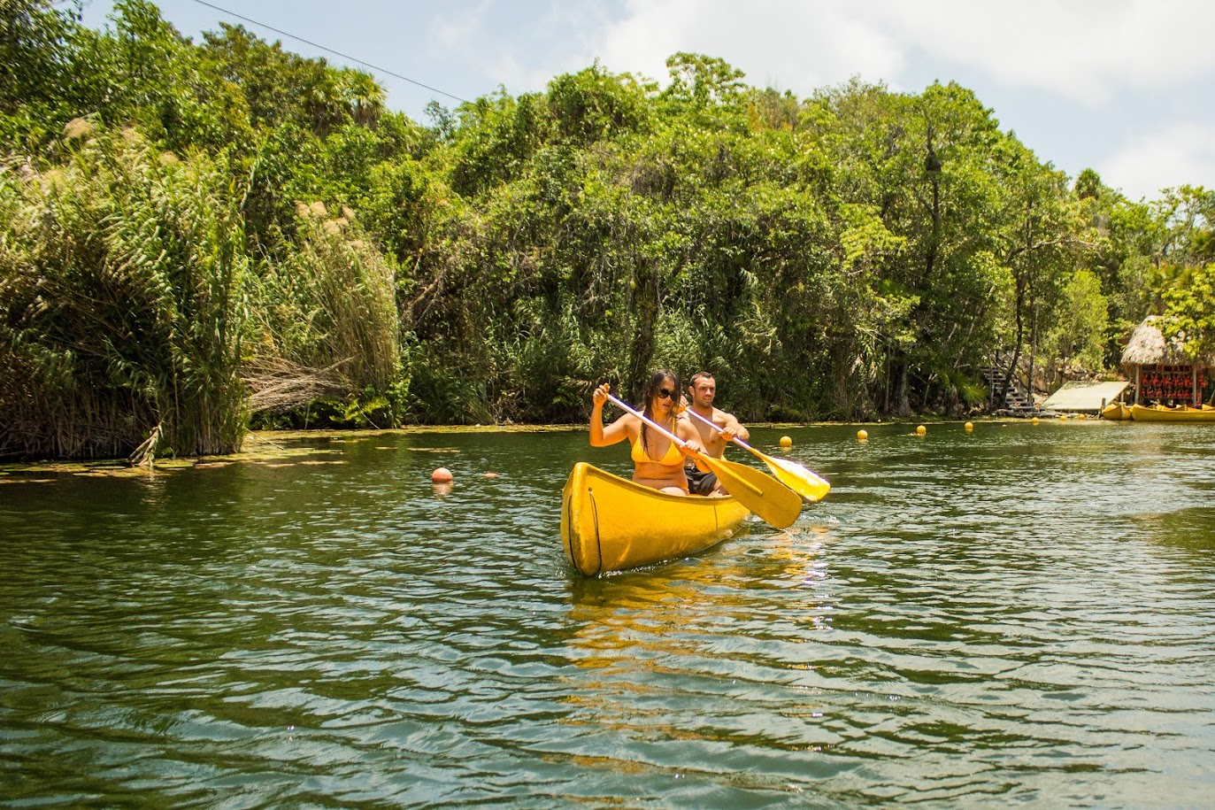 Canoeing across a freshwater lagoon in the jungle