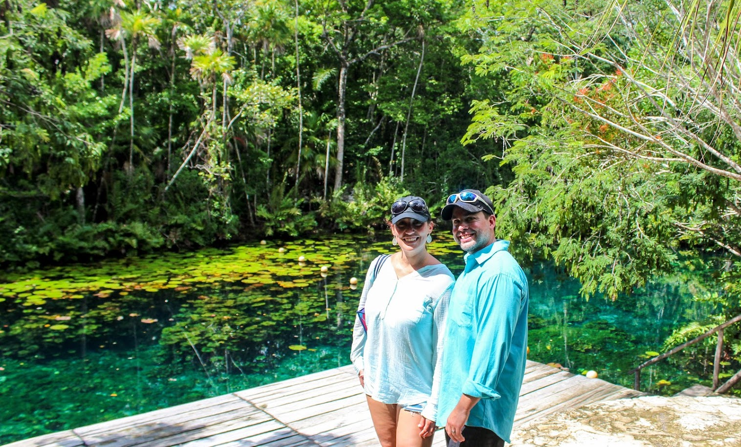 Couple beside a cenote in the Tulum jungle